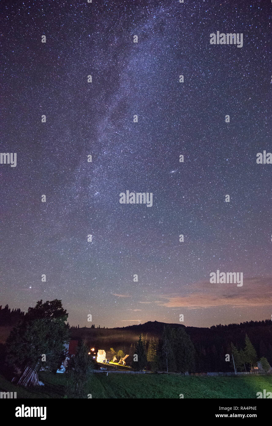 The Milky Way rising over the Carpathian Mountains, Romania Stock Photo