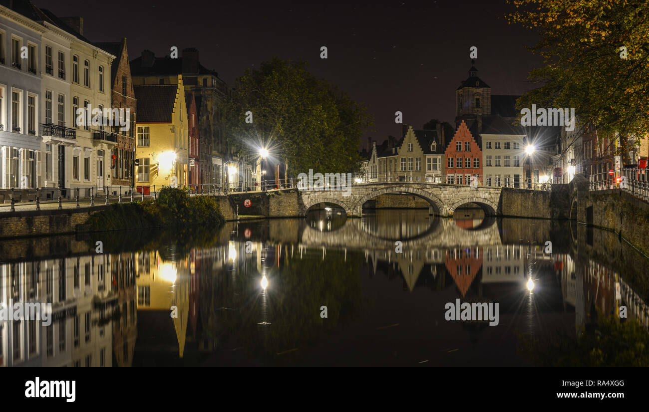 Scenic city view of Bruges canal with beautiful medieval colored houses