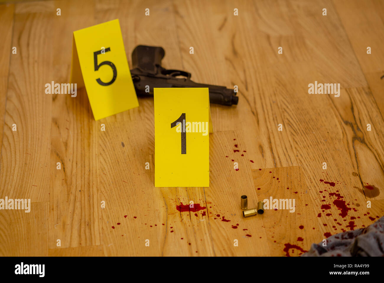 Bullet casings and gun next to markers at crime scene Stock Photo - Alamy