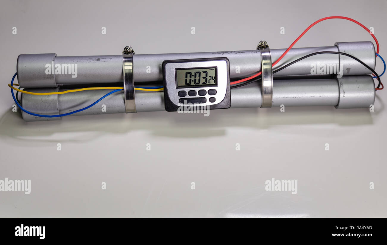 Pipe bomb with an lcd clock timer to trigger detonation on white background Stock Photo