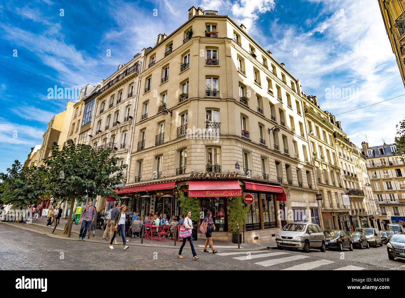People dining outside Le Café Bruant , 59 Rue des Abbesses , as people pass by , Montmartre ,Paris Stock Photo