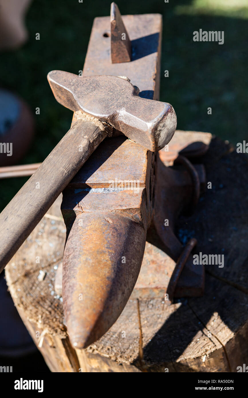 Old rusty iron anvil and hammer Stock Photo