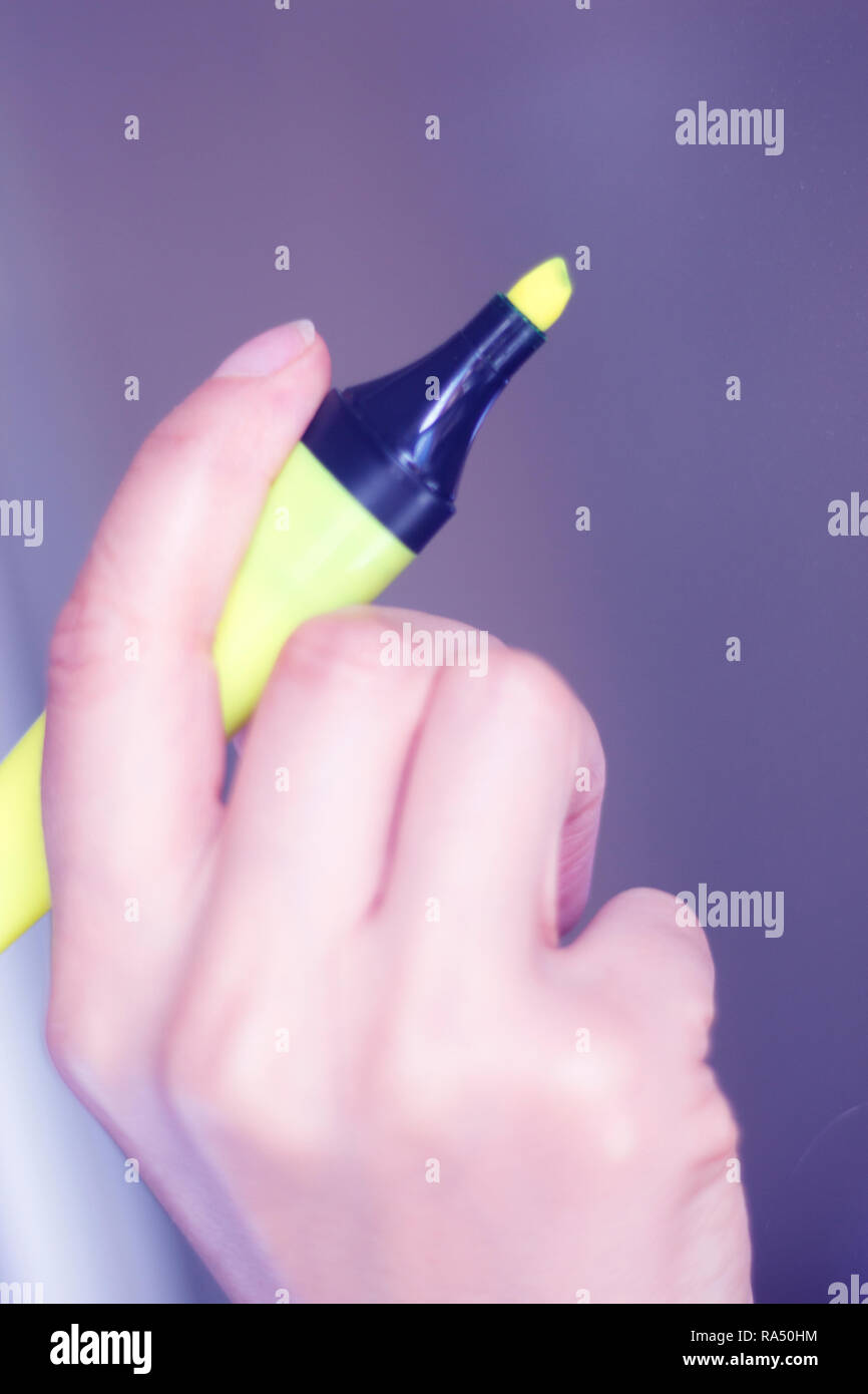 Felt tip permanent highlighter color ink marker pen in hand of young ...