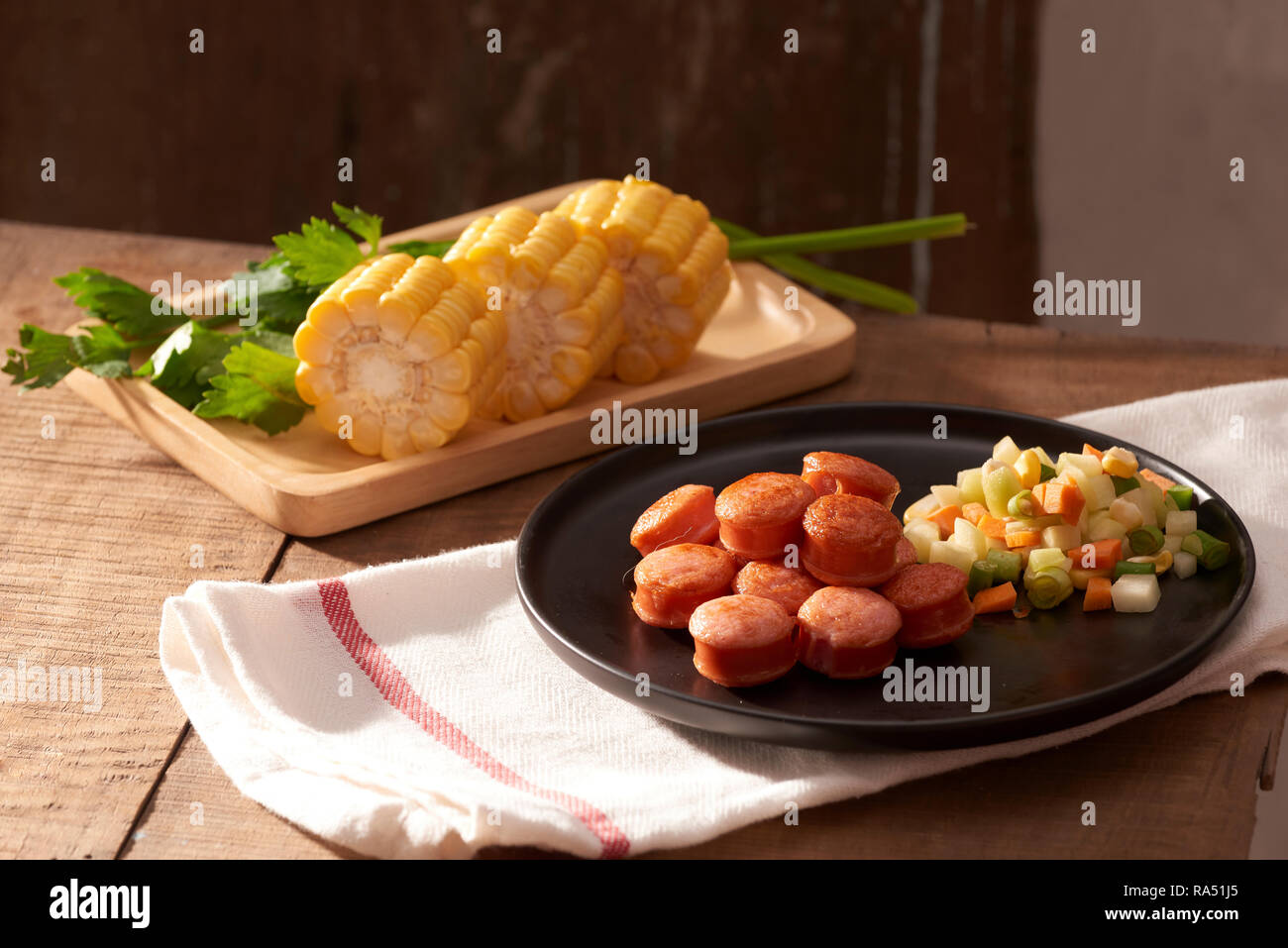 Sliced and fried sausage with salad seen from above close Stock Photo