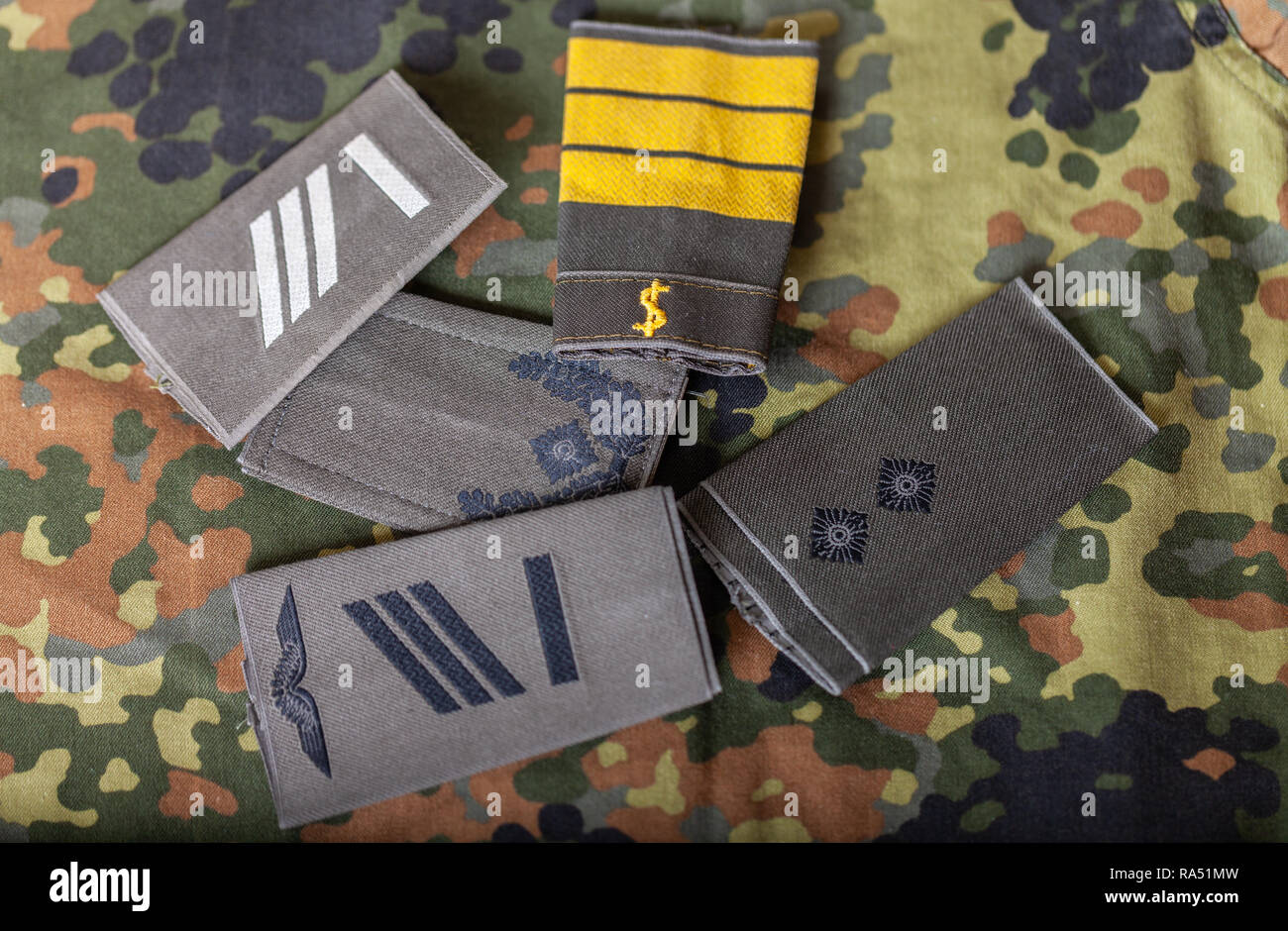 german shoulder ranks on a camouflage background Stock Photo - Alamy