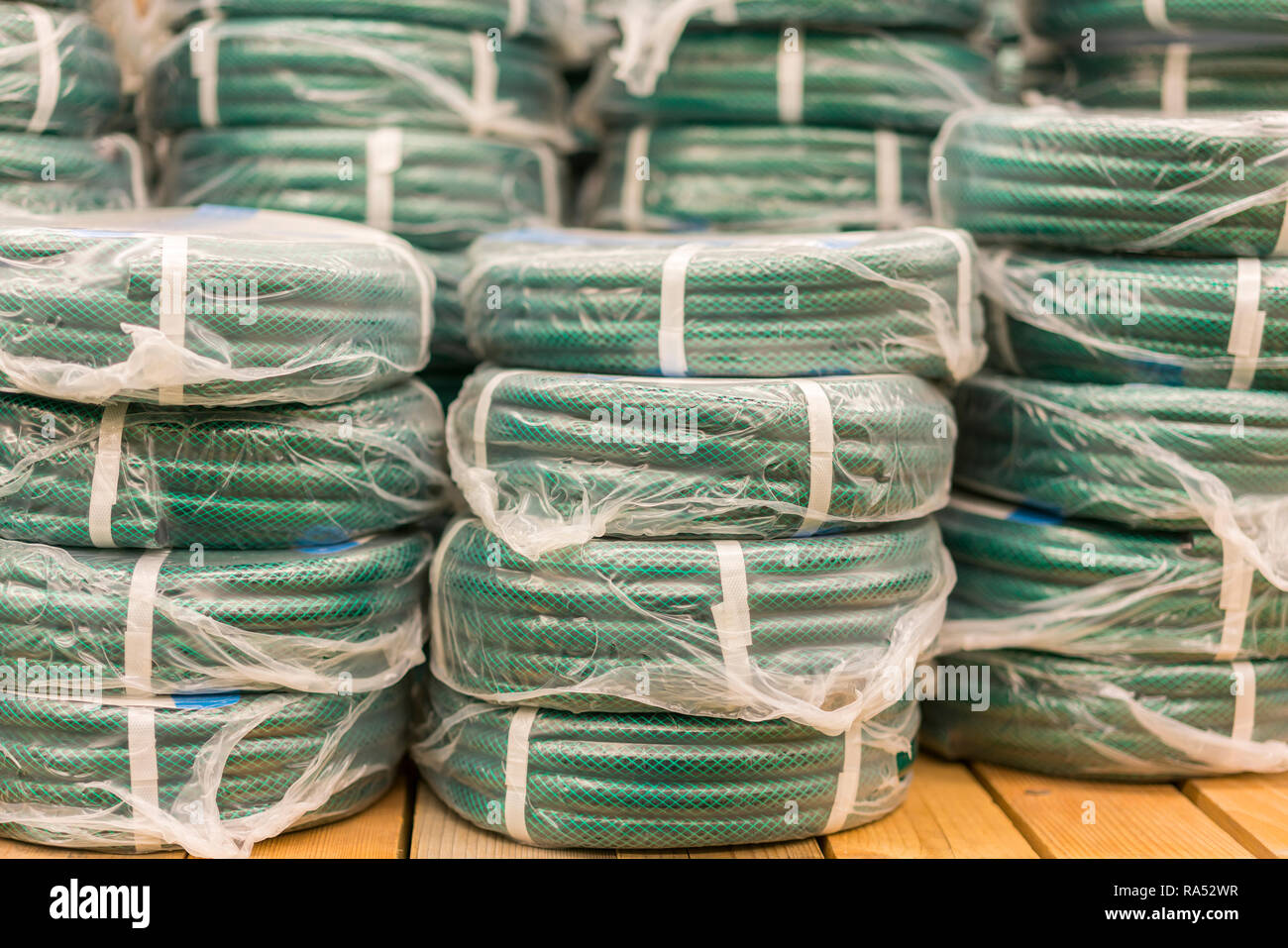 stacks of rolls yellow pvc plastic pipe on the counter in the store