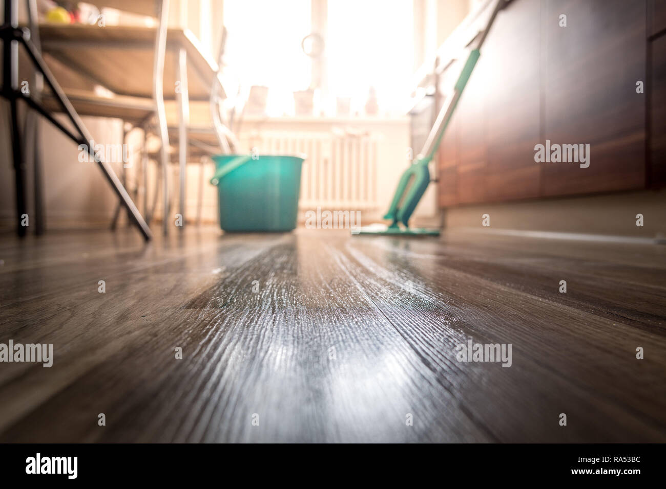 Wiping dirty wooden floor by wet wiper mop, housework Stock Photo Alamy