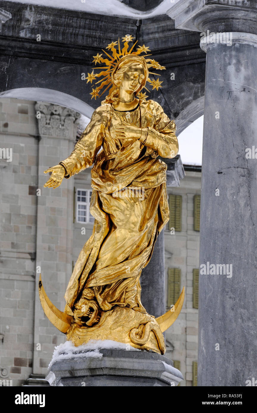 A Catholic shrine of the gold statue of 'Our Lady' in front of the
