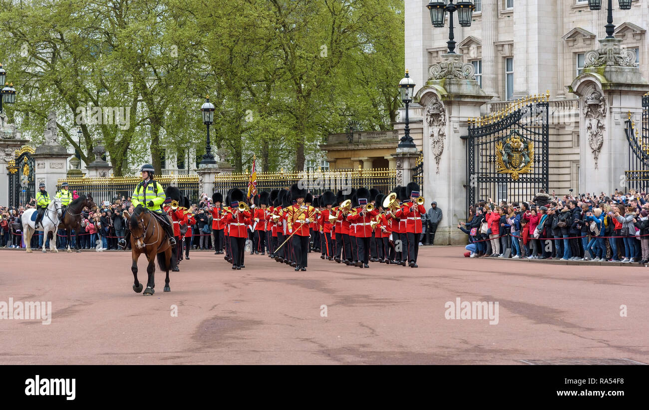 London, UK - April 29, 2018: Soldiers of the Royal Guard leave the Buckingham Palace during changing the guard ceremony. Stock Photo