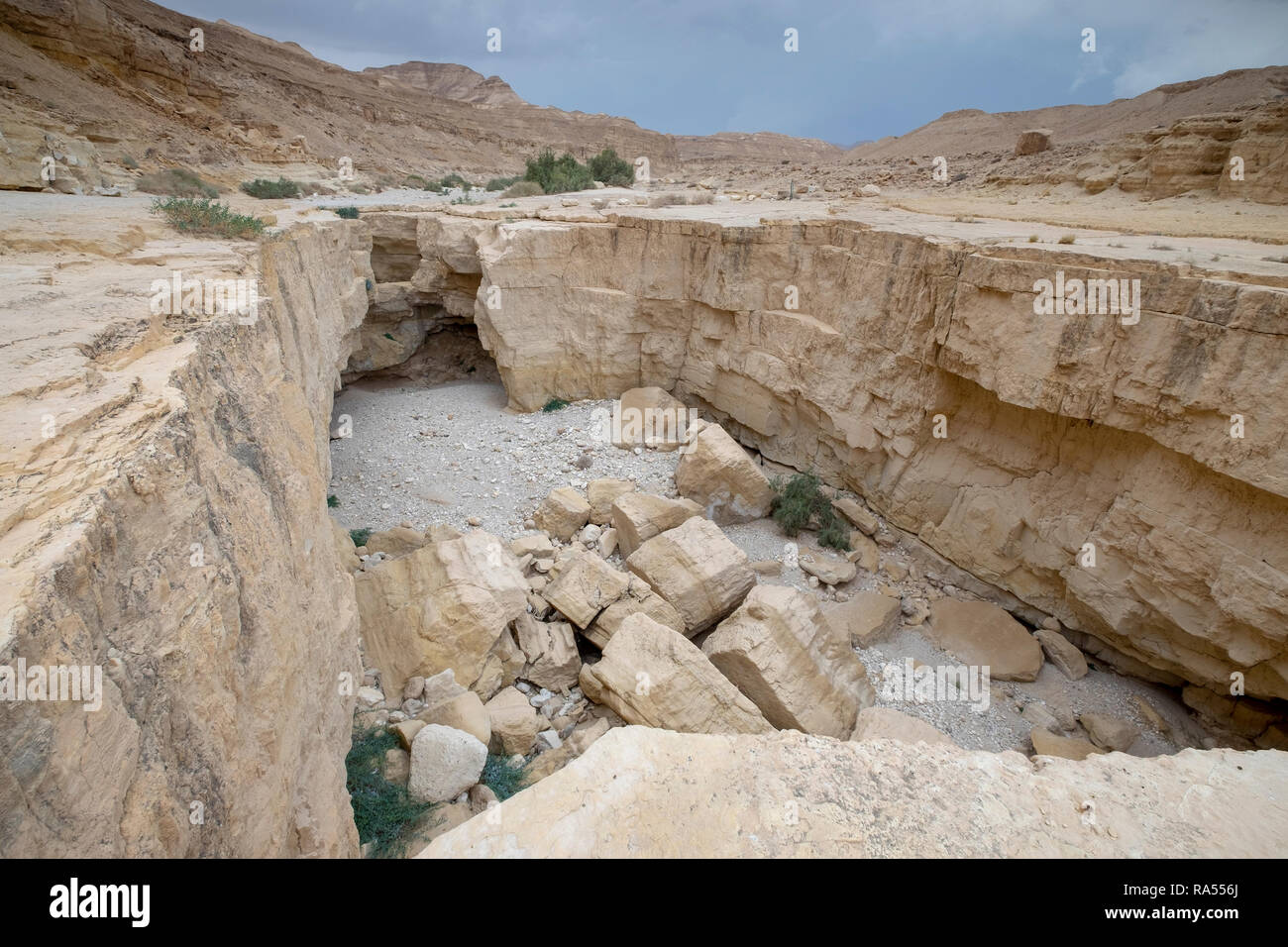A deep dry river gorge cut in the dry sandstone by flood water. The only water that flows into the Dead Sea, Israel Stock Photo