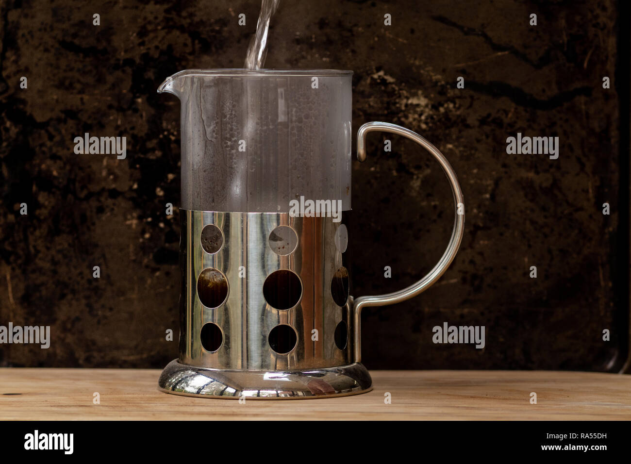 Pouring boiling water into cafetiere Stock Photo