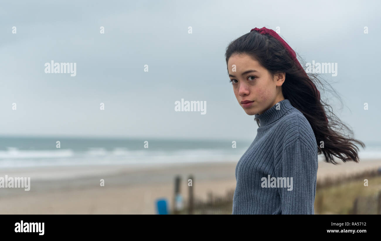 Young Asian American At North Carolina Beach In Winter With Maroon