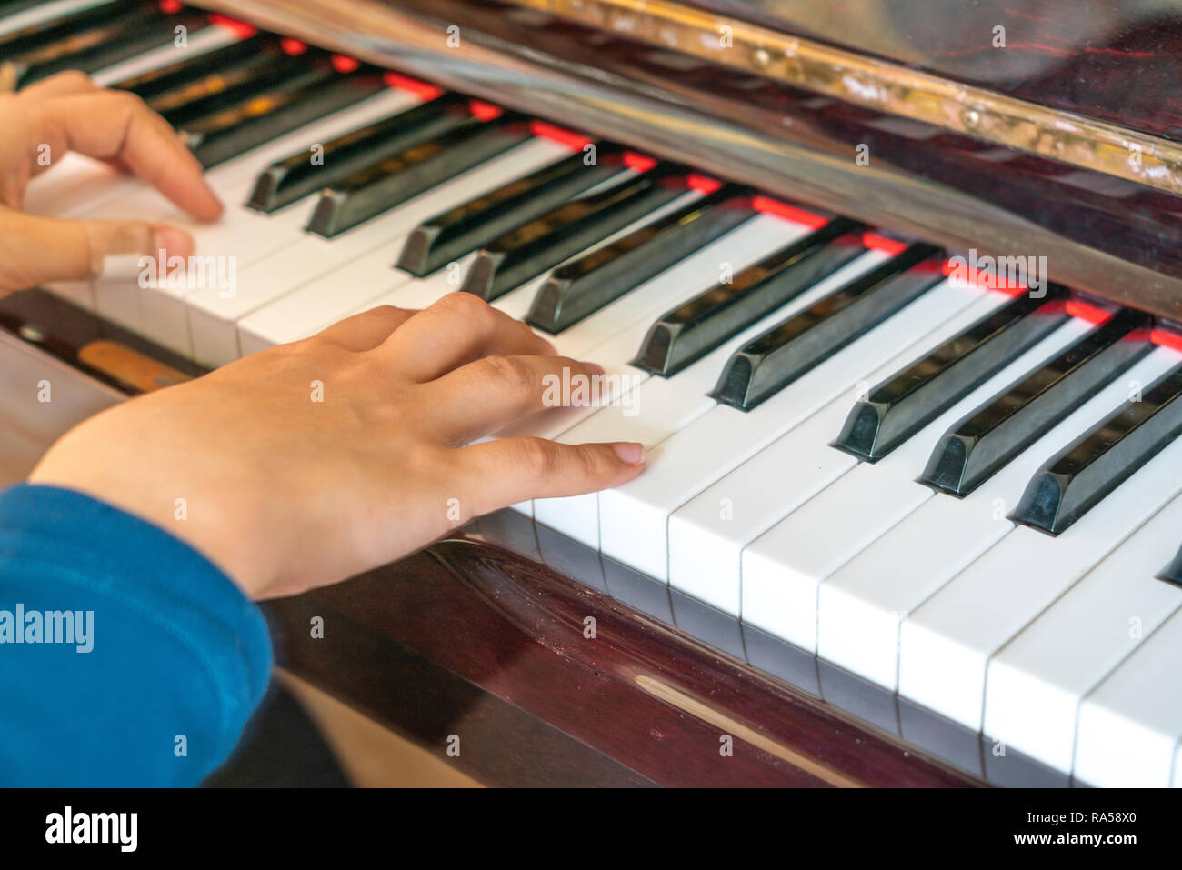 Female hands playing on old piano Stock Photo