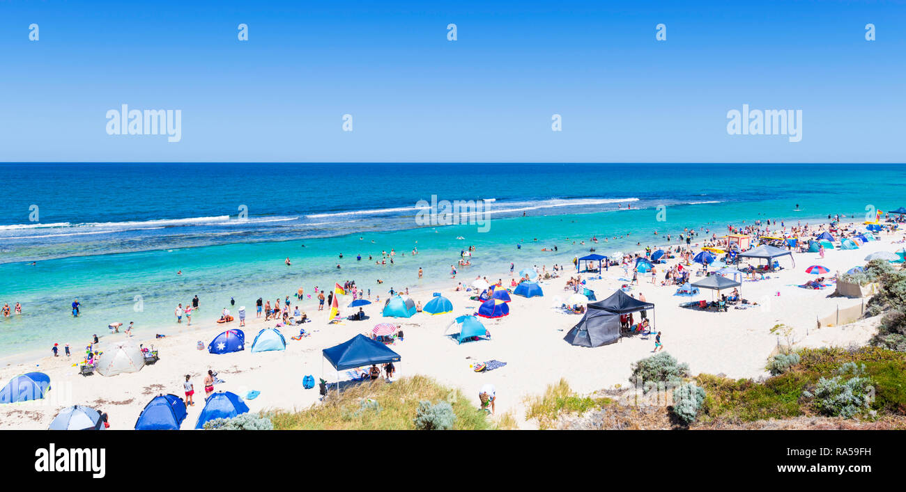 Beach tents, shelters and sunshades on a crowded beach in the middle of the day with a UV rating of 13. Yanchep, WA, Australia Stock Photo
