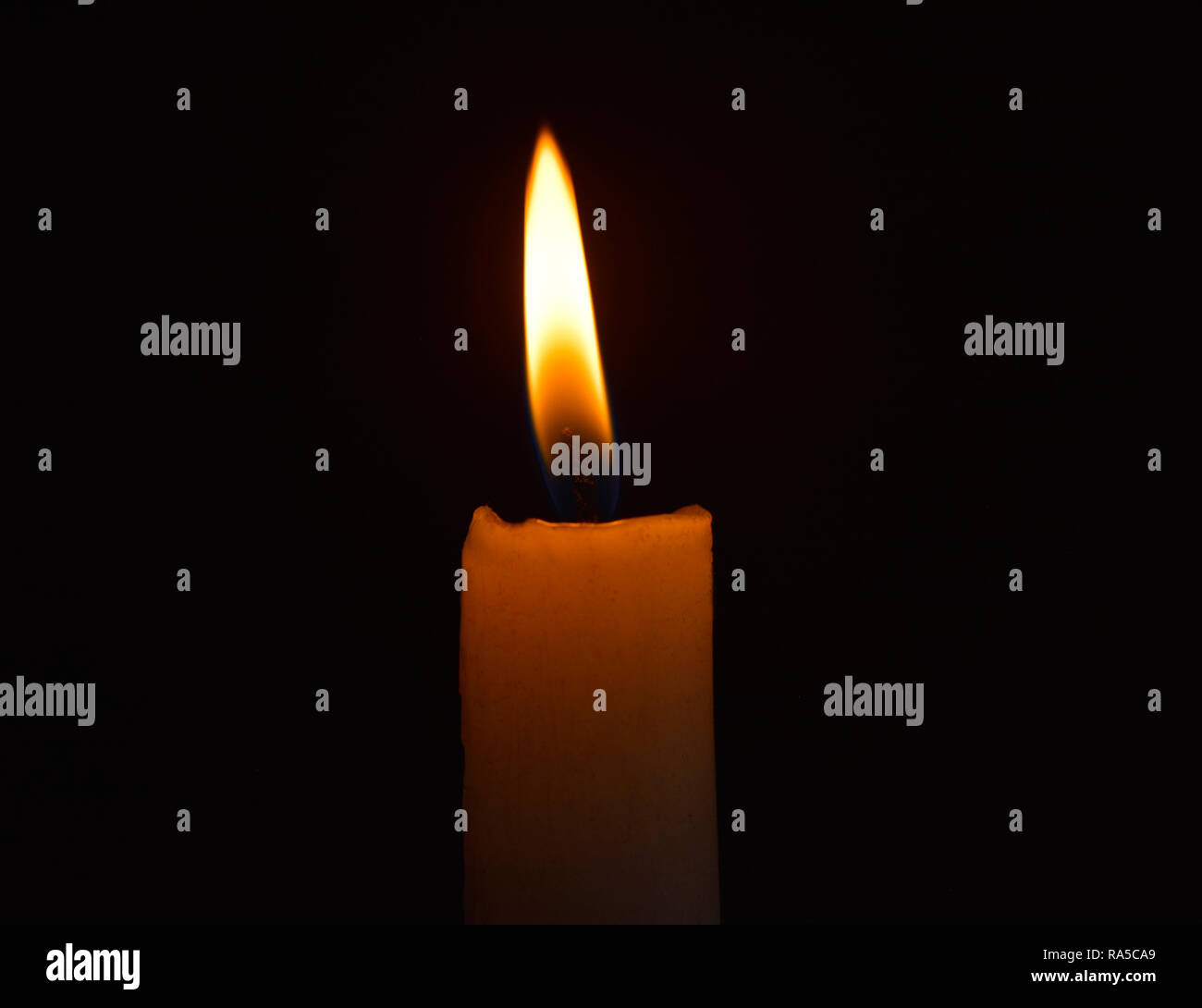 Single lit candle with quite flame Stock Photo Alamy