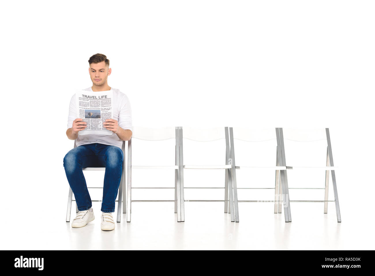 handsome alone young man reading newspaper isolated on white Stock Photo