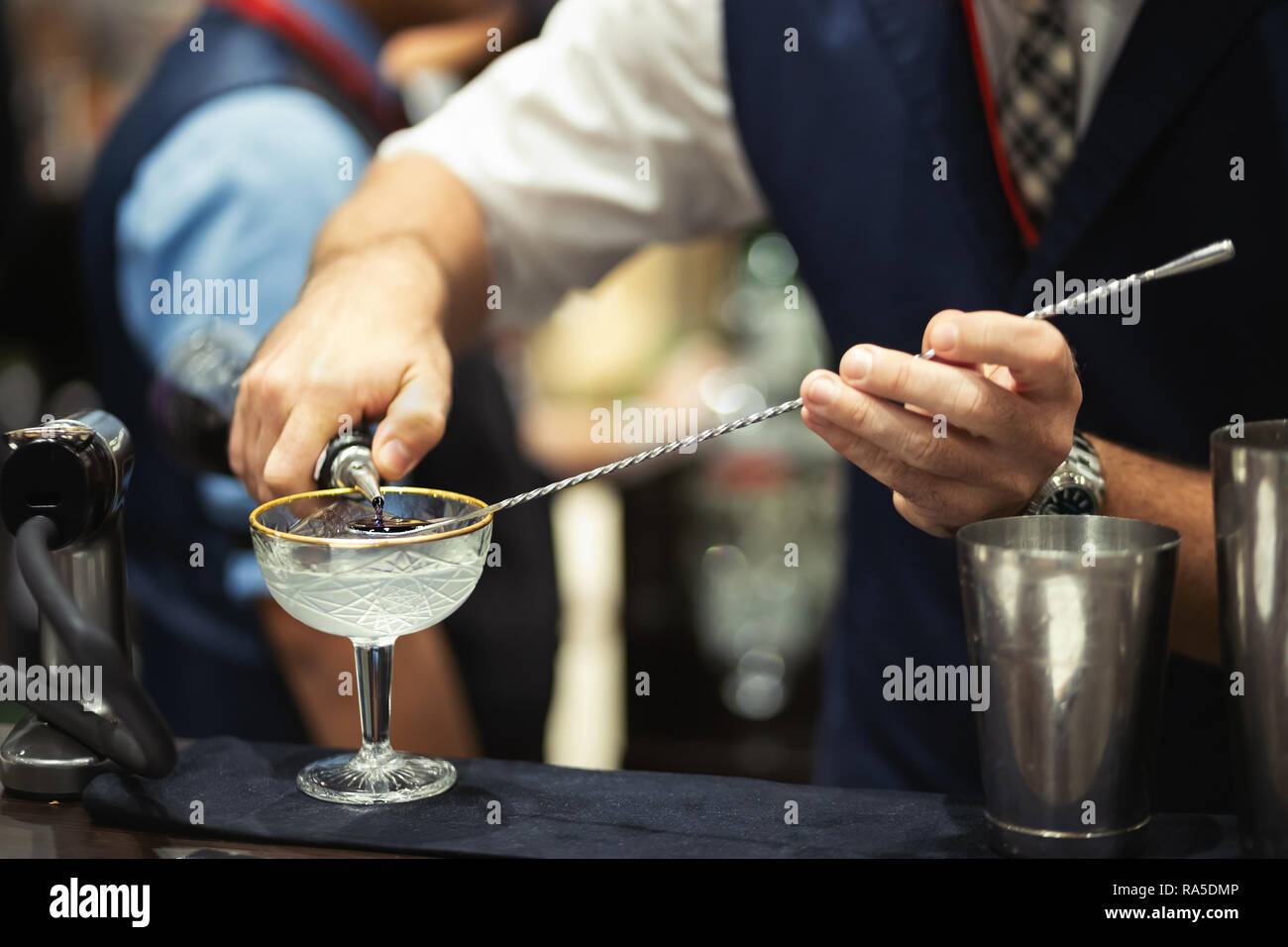 Barmen makes cocktail using a bar spoon Stock Photo Alamy