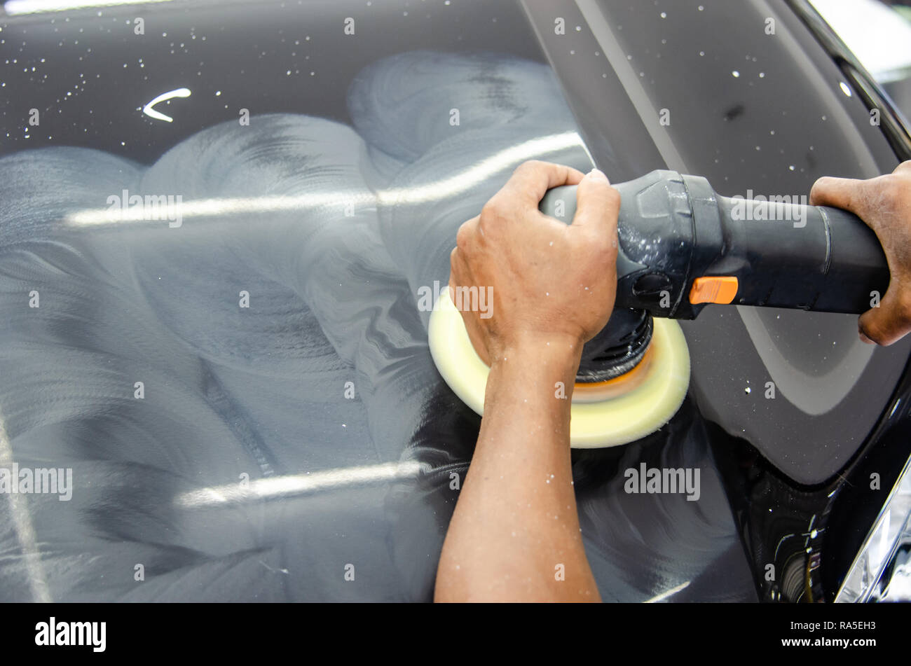 Mechanic hand holding the car polish Stock Photo