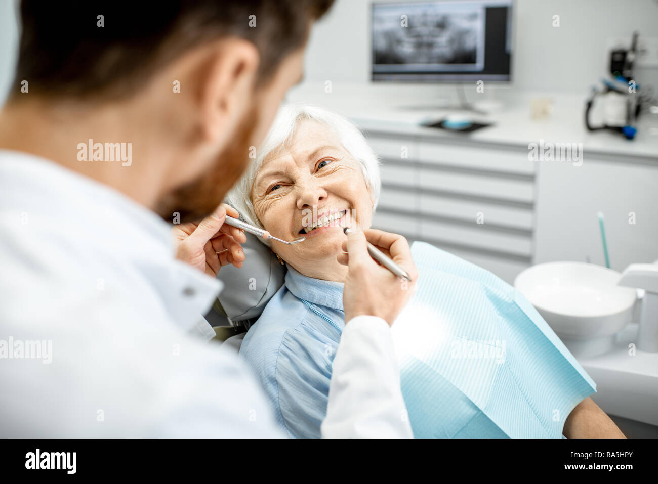 Elderly woman during the medical examination with male dentist in the dental office Stock Photo
