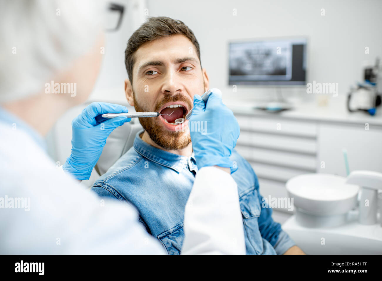 White male patient at the dentists office hires stock photography and