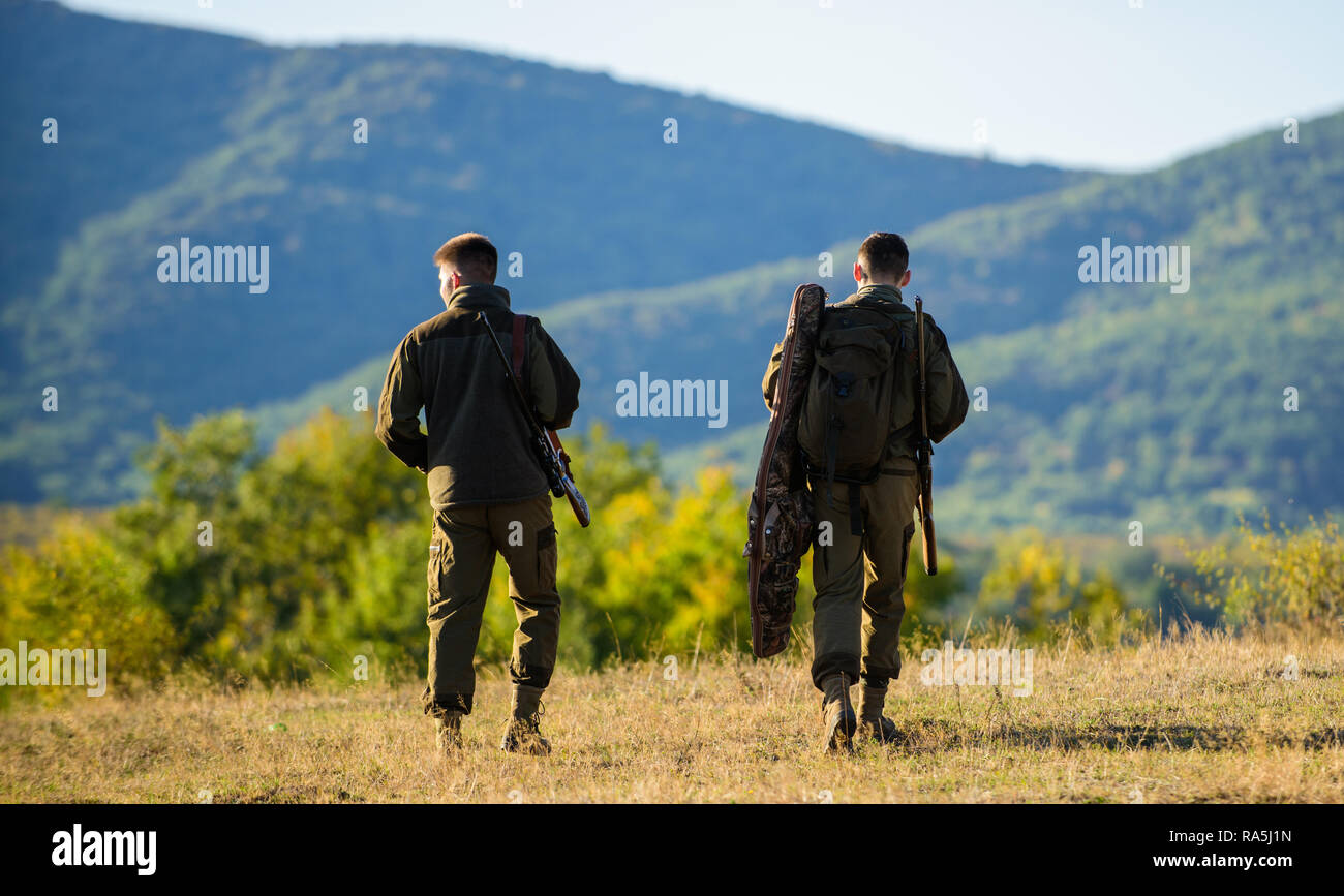 Hunters friends gamekeepers walk mountains background. Hunting with
