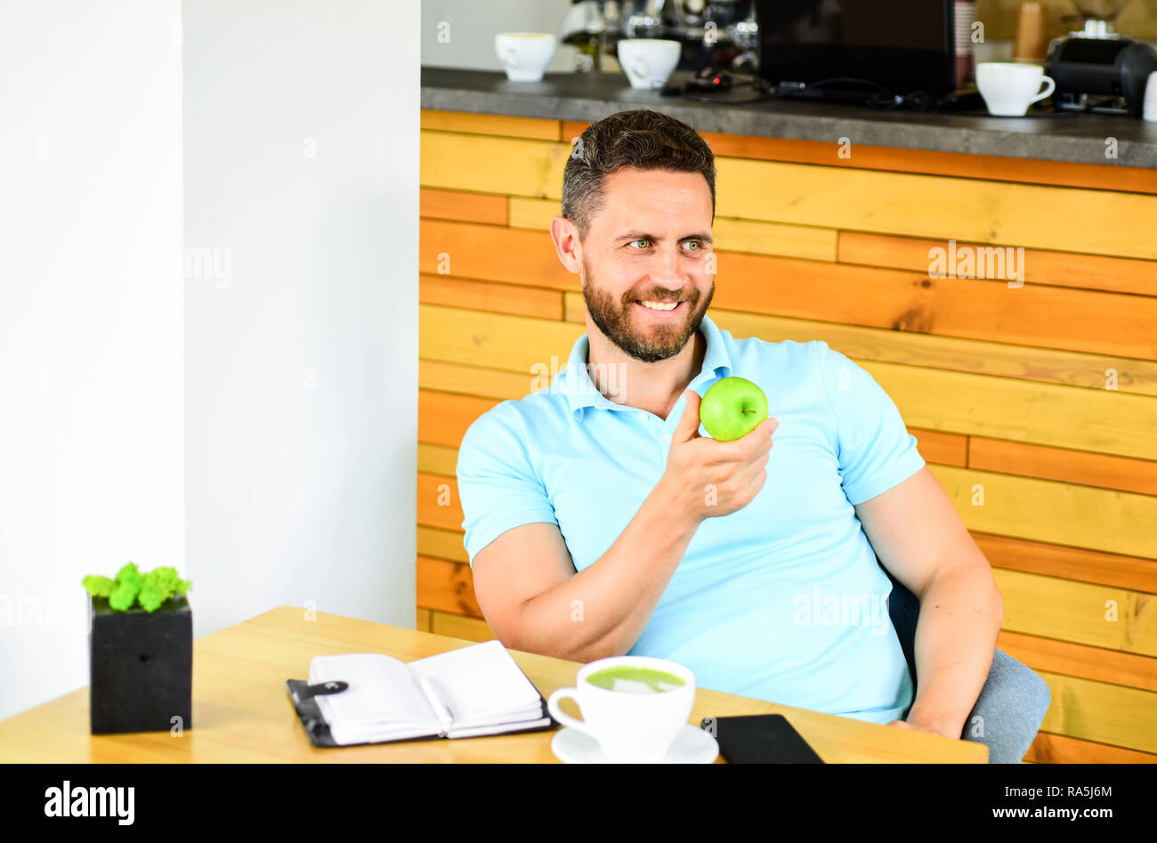 Man sit eat green apple fruit. Healthy snack. Lunch eat apple. Healthy