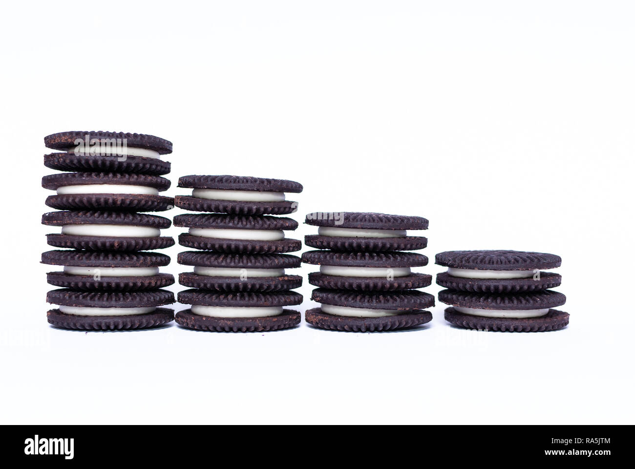 Vegan black and white chocolate sandwich cookies on white background Stock Photo