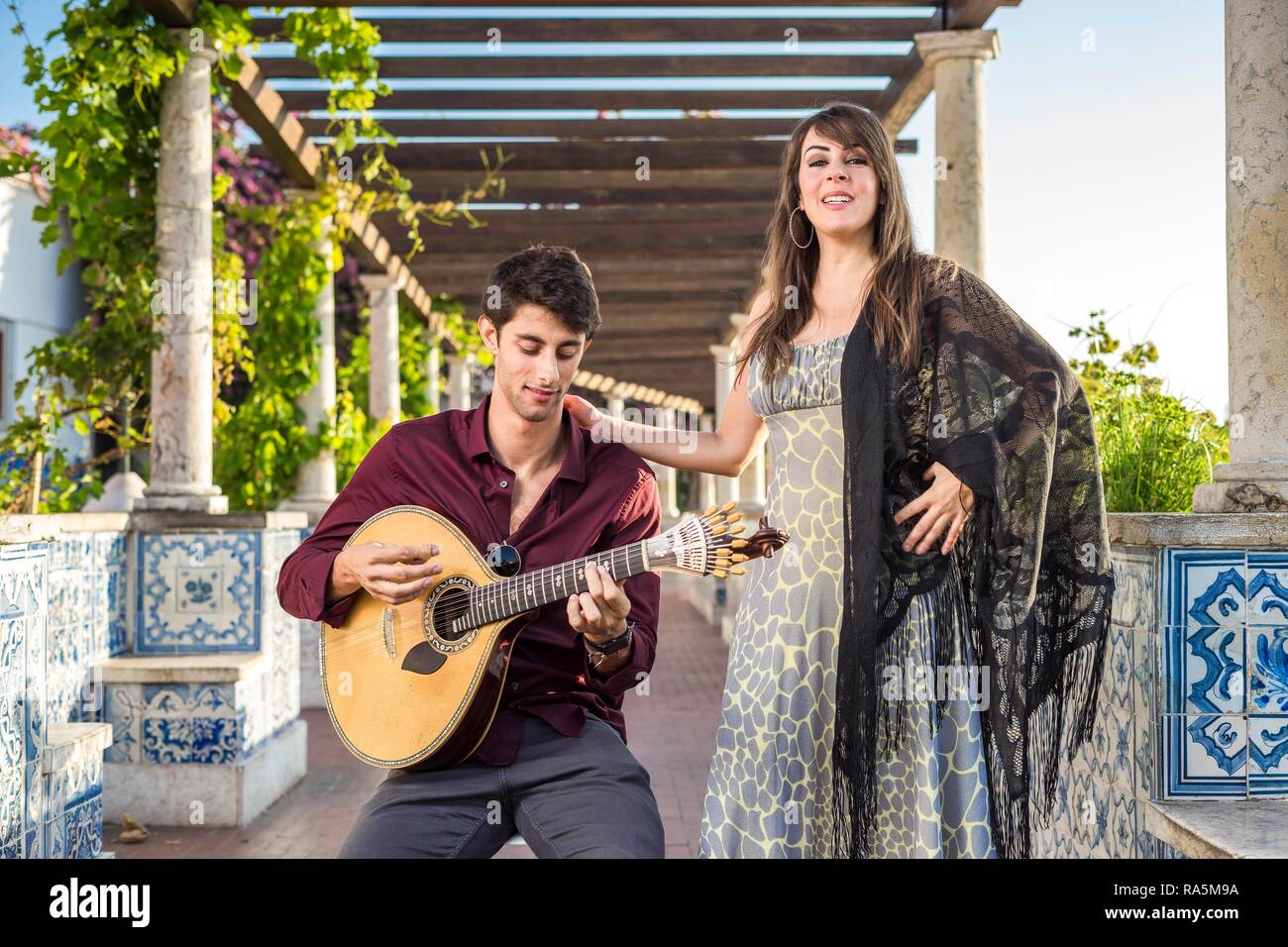 Two musicans, traditional music fado under pergola, Lisbon, Portugal Stock Photo