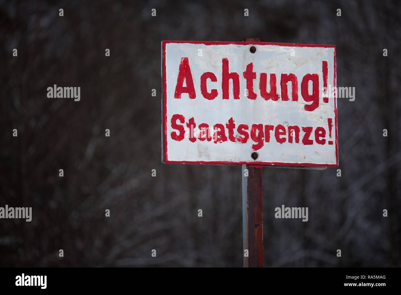 Sign with the inscription warning national border, Germany Stock Photo