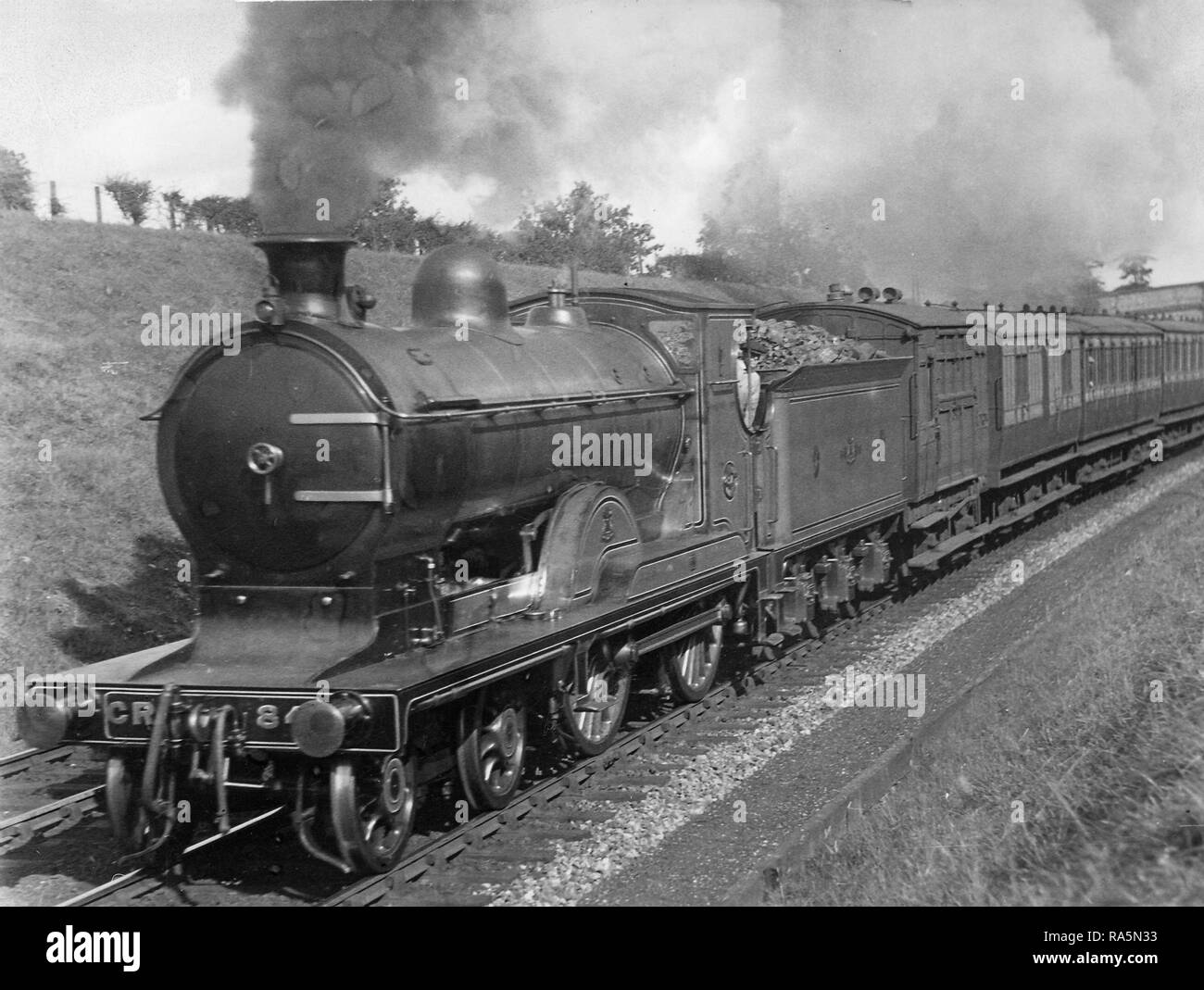 Caledonian Railway Pickersgill Class 72 4-4-0 steam locomotive hauling a train near Cove in Aberdeenshire Stock Photo