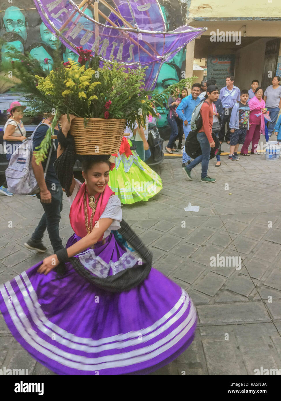 Dancers in beautifully colored traditional clothing with baskets on