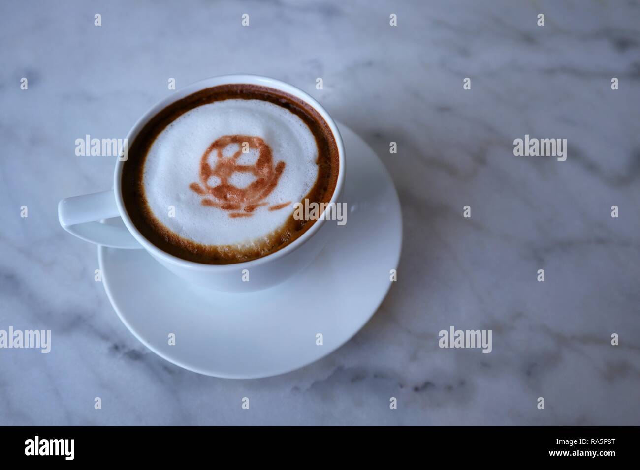 3d football latte art coffee on the marble table at cafe Stock Photo