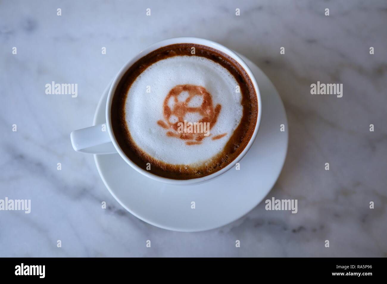 3d football latte art coffee on the marble table at cafe Stock Photo