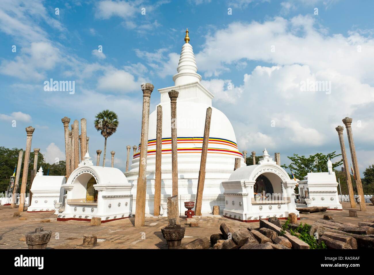 White Stupa, colorful ribbon in the colors of Buddhism, single standing columns, watadage, Thuparama-Dagoba, Anuradhapura Stock Photo