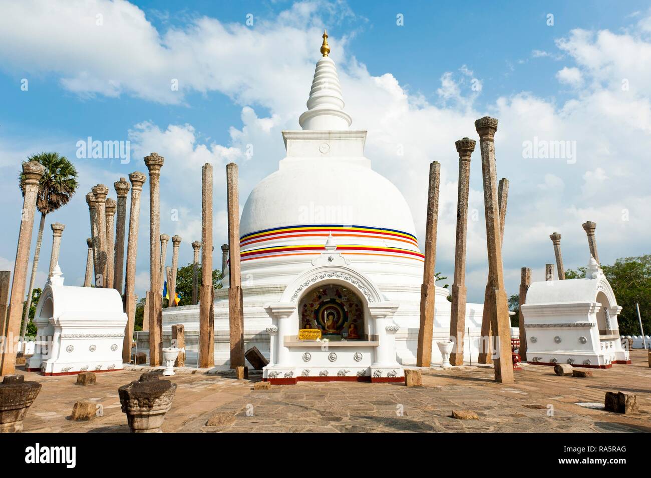 White Stupa, colorful ribbon in the colors of Buddhism, single standing columns, watadage, Thuparama-Dagoba, Anuradhapura Stock Photo