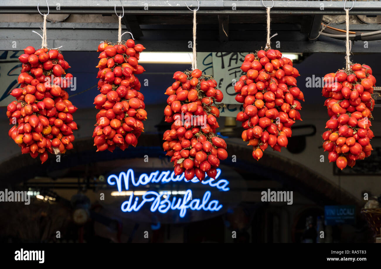 Pomodorino del Piennolo del Vesuvio, Vesuvio Piennolo cherry tomatoes, hanging above a shop doorway in the Centro Storico,  Naples, Italy. Stock Photo
