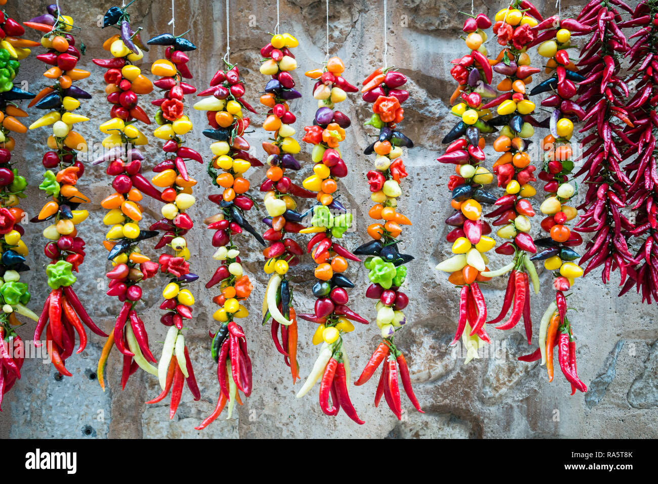 Mix of fresh peppers in various colors sold on the market Stock Photo