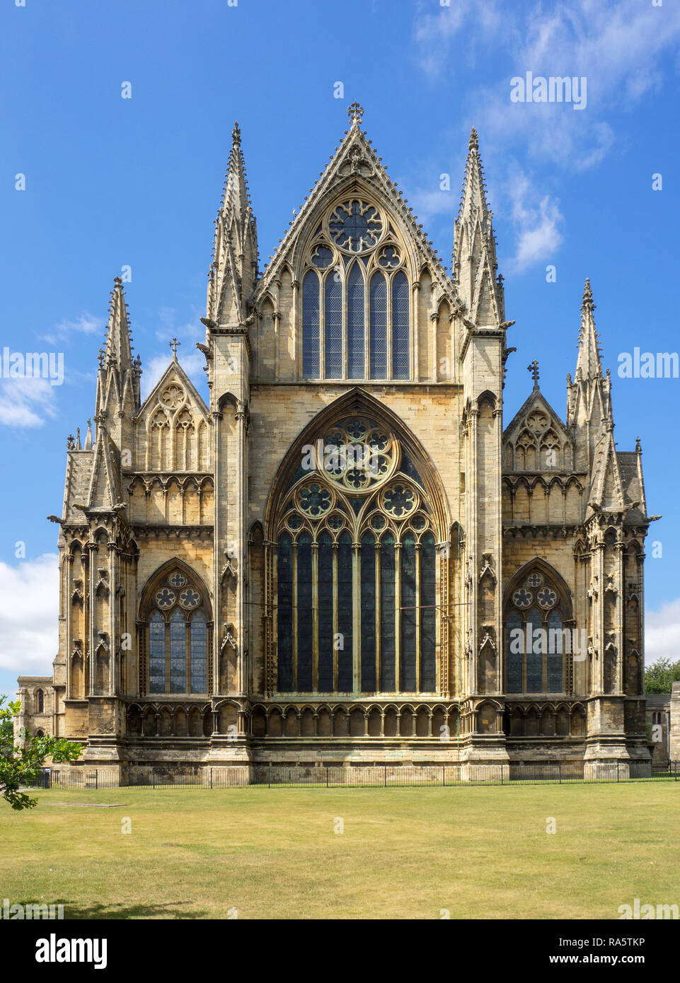 Gothic cathedral in Lincoln, Lincolnshire, England, UK. Presbytery with rosettes and lancet windows with stained glass Stock Photo