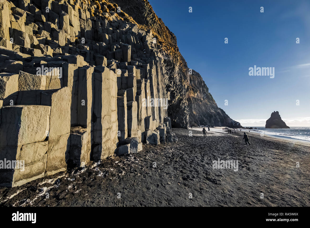 Columnar basalt formations along Reynisfjara Black Sand Beach in Iceland {No model releases; available for editorial licensing only] Stock Photo
