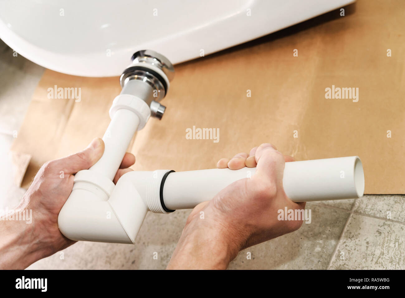Hands man mounted sewer drain with pop-up waste for bidet Stock Photo -  Alamy
