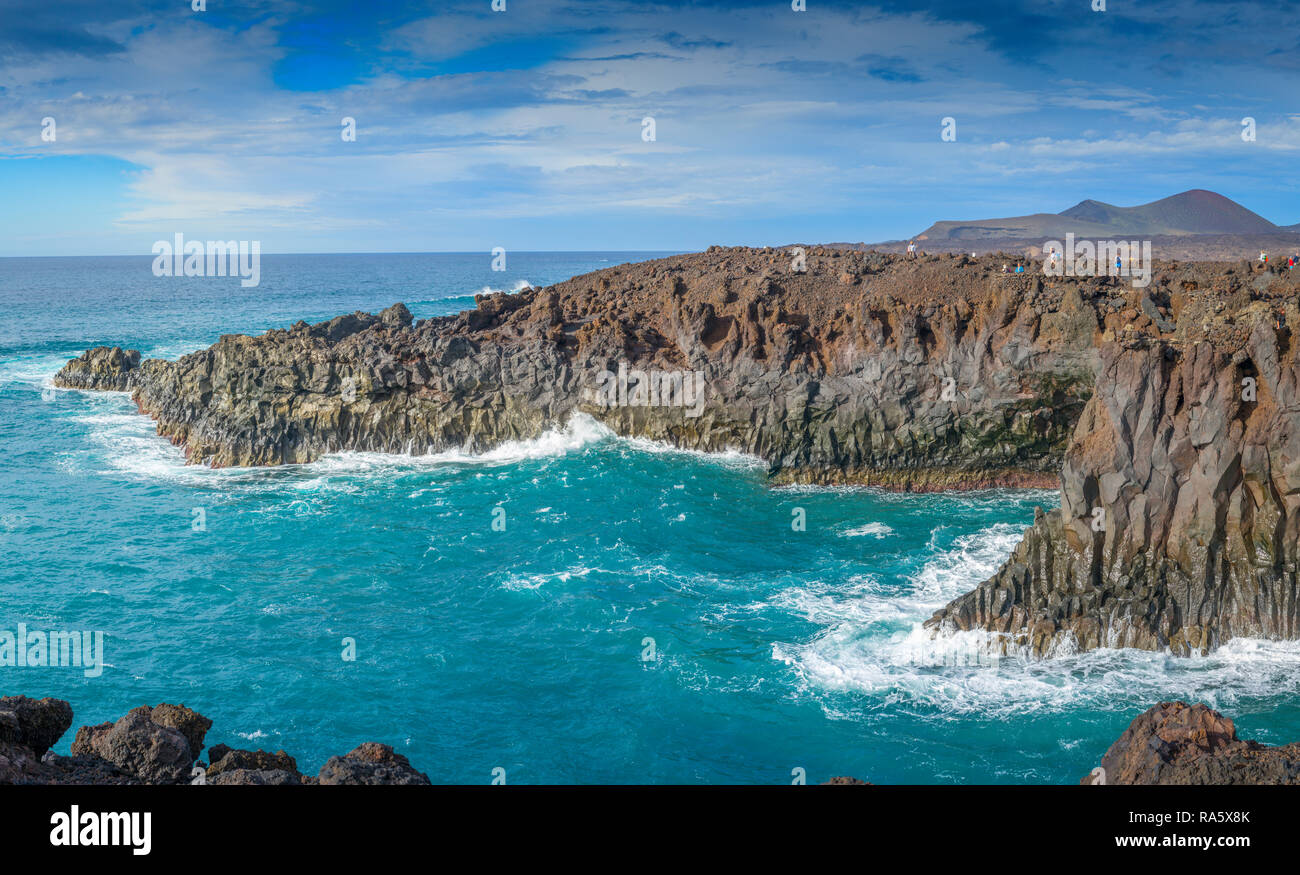 The rugged volcanic coastal rocks of Los Hervideros on the Islands of Lanzarote, pounded by the ferocious Atlantic Sea Stock Photo
