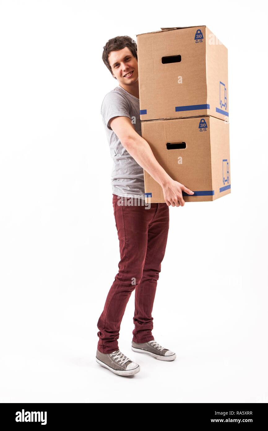 Young man carrying moving boxes Stock Photo