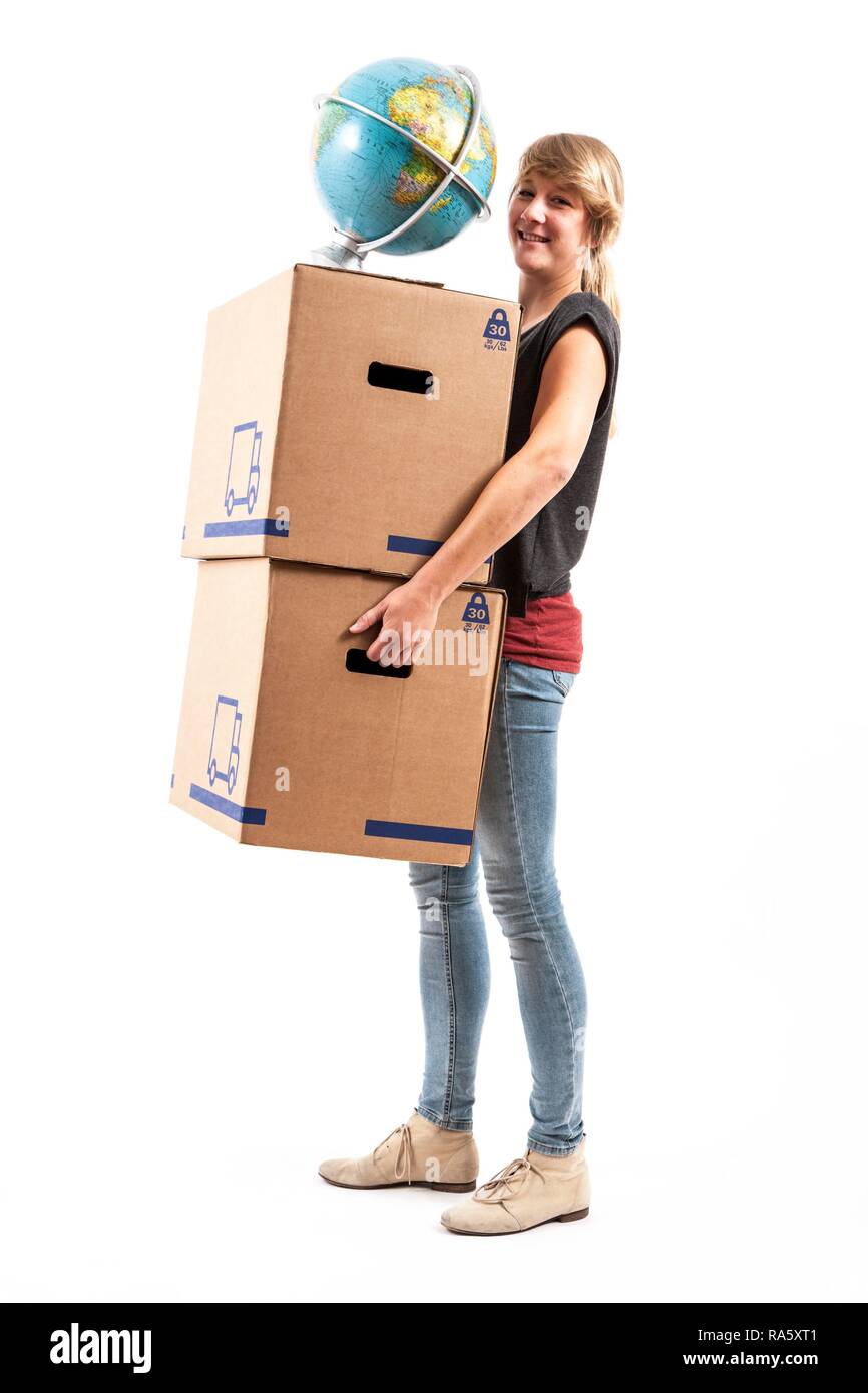 Young woman carrying moving boxes and a globe Stock Photo