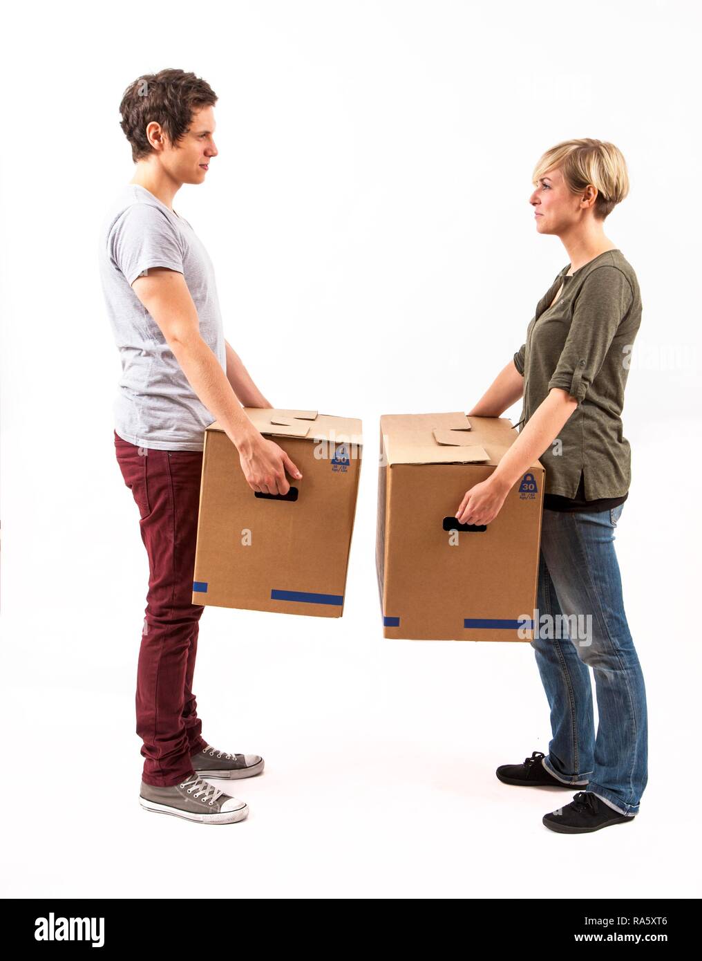 Young couple carrying moving boxes Stock Photo