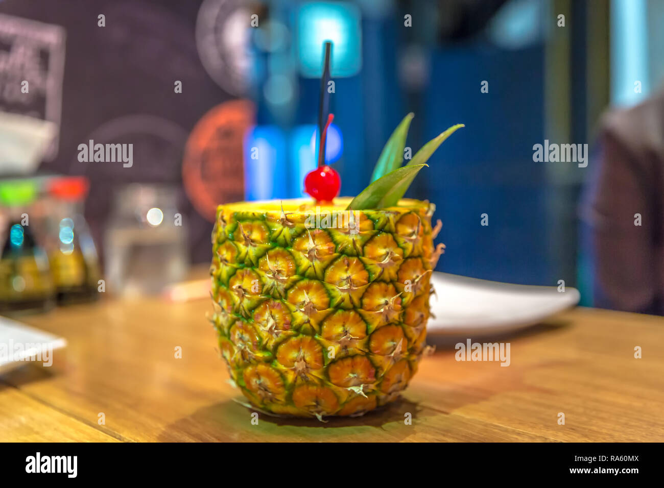 A drink served inside a pineapple Stock Photo Alamy