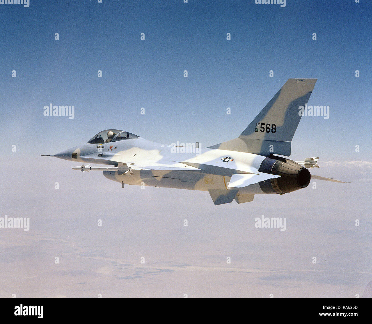 1974 - An air to air left side view of a YF-16 Fighting Falcon aircraft armed with AIM-9 Sidewinder missiles on the wing tips. Stock Photo