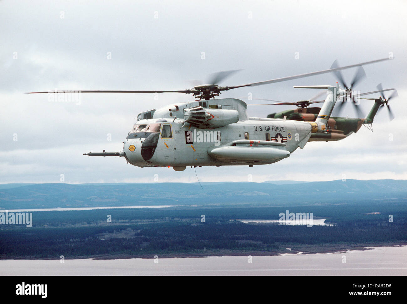 1978 - An air-to-air left side view of two 39th Aerospace Rescue and Recovery Wing HH-53 helicopters over Goose Bay while en route from Eglin Air Force Base, Florida, to Woodbridge, England. Stock Photo