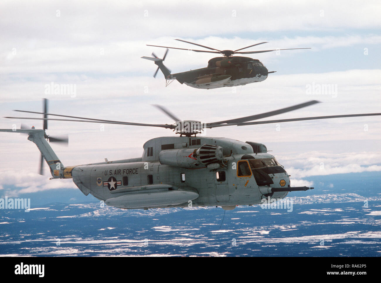 1978 - An air-to-air right side view of two 39th Aerospace Rescue and Recovery Wing HH-53 helicopters over Goose Bay while en route from Eglin Air Force Base, Florida, to Woodbridge, England. Stock Photo