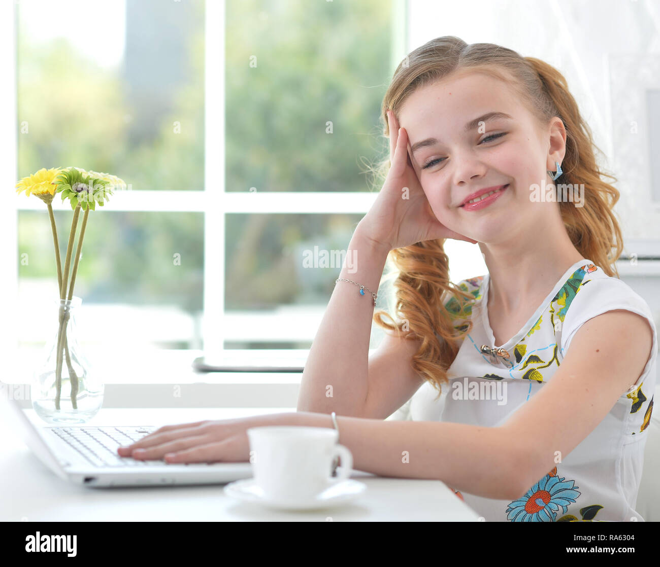 Portrait of little girl with modern laptop Stock Photo - Alamy