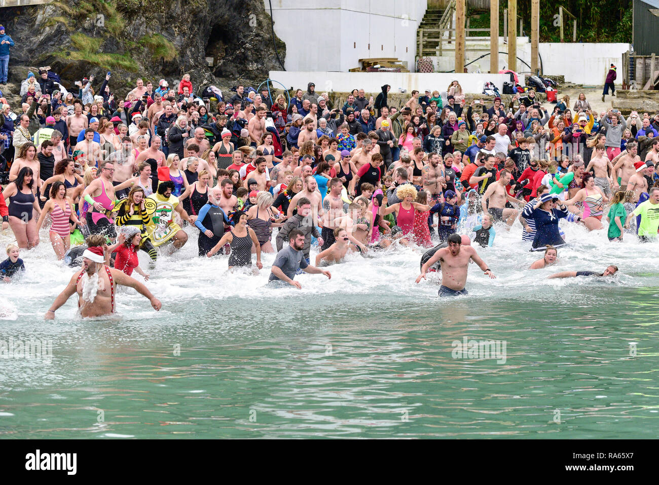 Newquay, Cornwall, UK.  1st January, 201p.  A massive turnout of hardy swimmers who braved to chilly waters of Newquay Harbour for the annual Newquay New Year’s Day Dip.  The ‘Dip’ is held to raise funds for the CLIC SARGENT charity that gives support to young people with cancer.  Gordon Scammell/Alamy Live News. Stock Photo